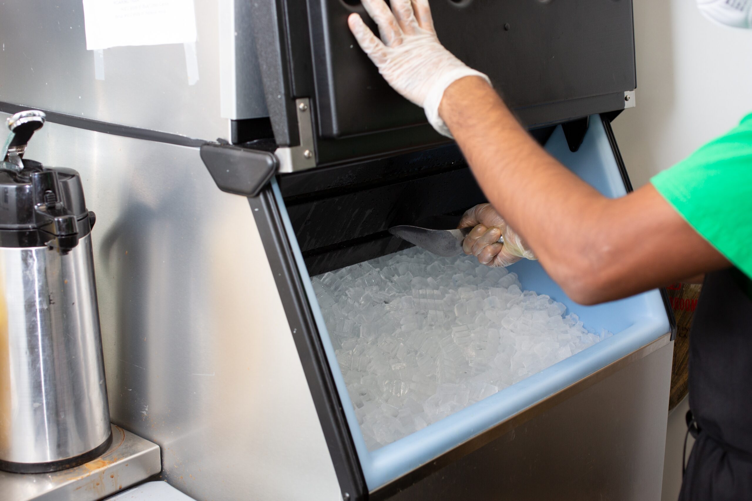 Ice Machine Employee Scooping Ice